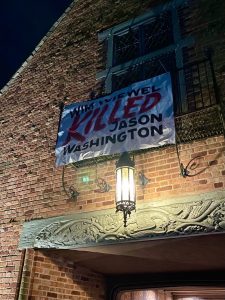 A banner hanging from the President's house on the Lewis and Clark College campus. The banner reads: Wim Wiewel KILLED Jason Washington