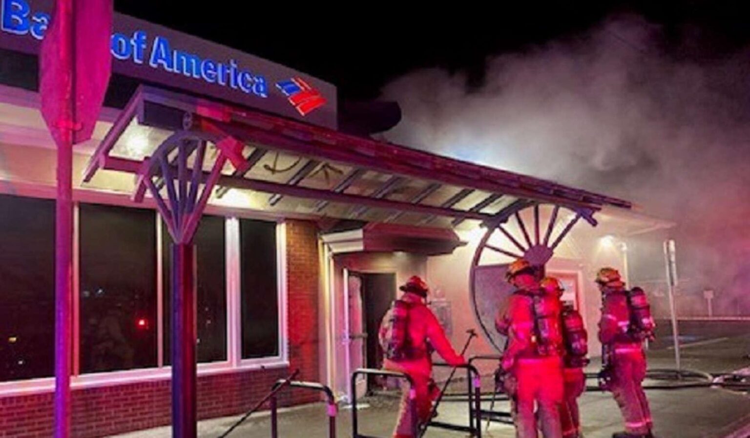 firefighters fighting a smoky fire at a bank of america